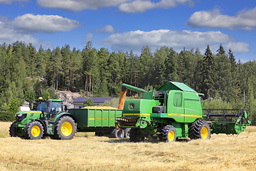 Image showing John Deere Combine Unloading Grain on Trailer