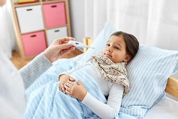 Image showing mother measuring temperature of sick daughter