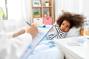 Image showing doctor with clipboard and sick girl in bed at home