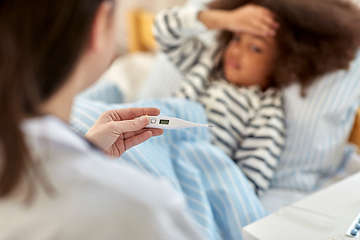 Image showing doctor measuring sick girl's temperature