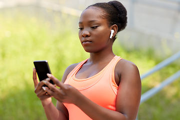 Image showing african american woman with earphones and phone