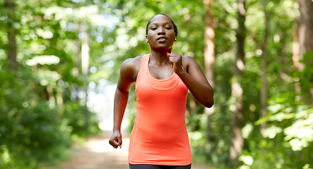 Image showing young african american woman running in forest