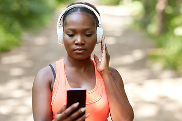 Image showing african american woman with headphones and phone