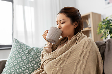 Image showing sick asian woman drinking hot tea at home