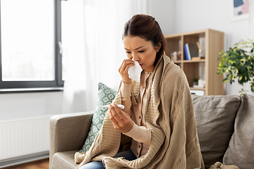 Image showing sick woman measuring temperature by thermometer