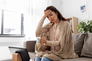 Image showing sick woman with medicine has video consultation