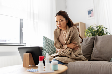 Image showing sick woman having video call on tablet pc at home