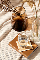 Image showing glass of water, decorative dried flowers in vases