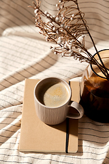 Image showing cup of coffee, diary and dried flowers in vases