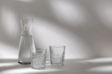 Image showing two glasses and jug with water on white background