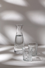 Image showing two glasses and jug with water on white background