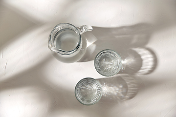 Image showing two glasses and jug with water on white background