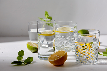 Image showing glasses with lemon water and peppermint on table