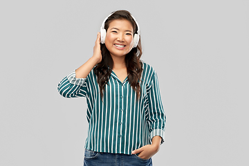 Image showing asian woman in headphones listening to music