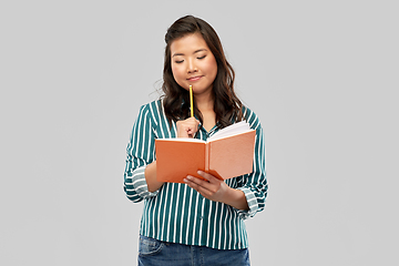 Image showing asian student woman with diary and pencil