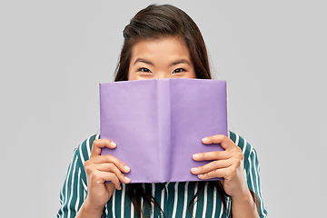 Image showing happy asian woman hiding behind