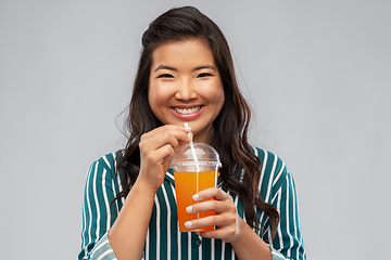 Image showing asian woman with juice in plastic cup with straw