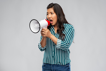 Image showing angry young asian woman speaking to megaphone