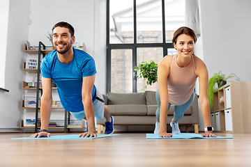 Image showing happy couple exercising at home