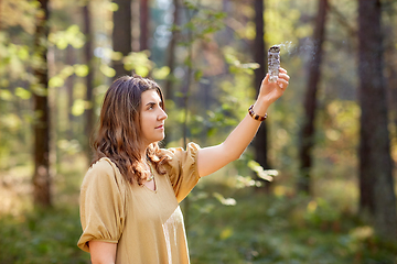 Image showing woman or witch performing magic ritual in forest