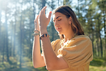 Image showing woman or witch performing magic ritual in forest