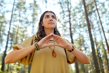 Image showing woman or witch performing magic ritual in forest