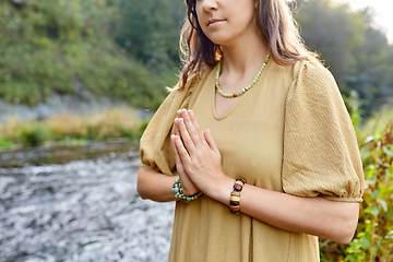 Image showing woman or witch performing magic ritual on river