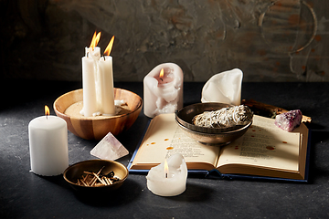 Image showing magic book, sage, burning candles and ritual staff