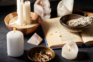 Image showing magic book, sage, burning candles and ritual staff