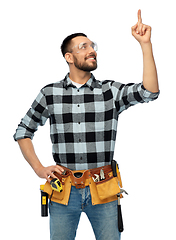 Image showing happy male worker or builder with tool belt