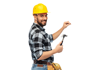 Image showing happy male builder in helmet with hammer and nail