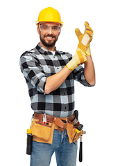 Image showing happy male worker or builder in helmet and gloves