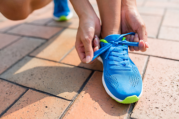 Image showing woman fixing the shoelace