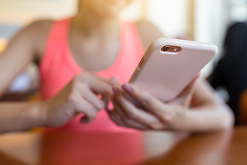 Image showing Woman sending sms on cellphone