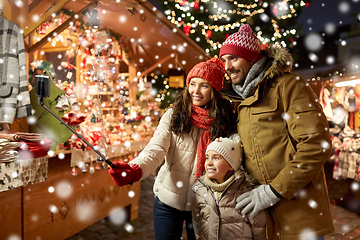 Image showing happy family taking selfie at christmas market