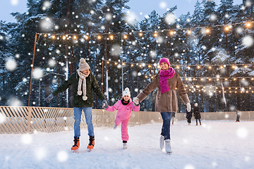 Image showing happy family at outdoor skating rink in winter