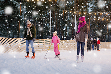 Image showing happy family at outdoor skating rink in winter