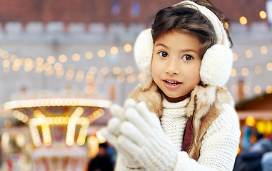 Image showing little girl in earmuffs at christmas market