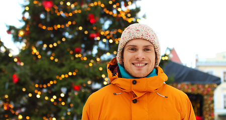 Image showing happy young man over christmas market background