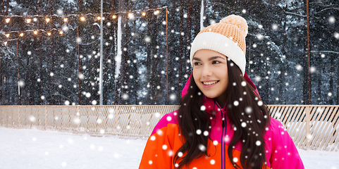 Image showing happy teenage girl over ice skating rink in winter