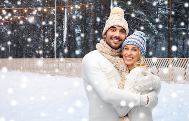 Image showing happy couple hugging on outdoor ice skating rink