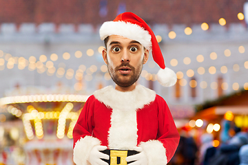 Image showing surprised man in santa costume at christmas market