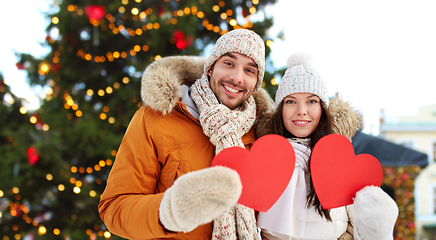 Image showing happy couple with red hearts at christmas market