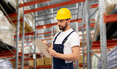 Image showing male loader or worker with clipboard at warehouse