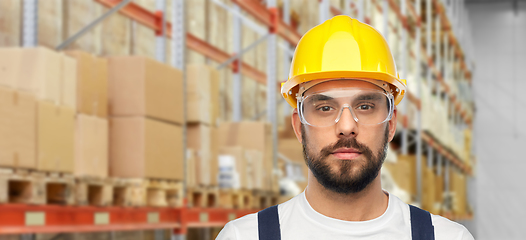 Image showing male worker or loader in helmet at warehouse