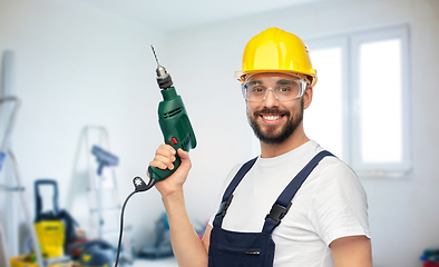 Image showing happy male worker or builder in helmet with drill