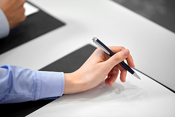 Image showing close up of businesswoman with paper at office