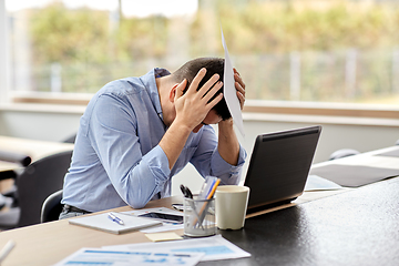 Image showing stressed man with laptop working at home office