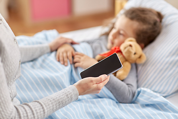 Image showing sick daughter and mother with phone at home