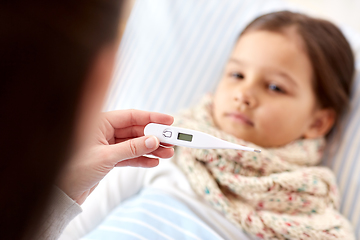 Image showing mother measuring temperature of sick daughter